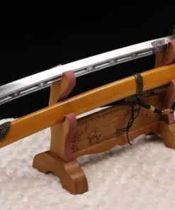 A Chinese Liuyedao sword displayed alongside its decorative, ornate scabbard, on a small wooden sword stand.