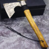 A short style of Viking bearded axe leaning against a small black box.