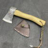 A small wood handle hatchet displayed lying next to its sheath.