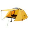 A yellow colored 4 person dome tent, with its front awning erected with guy-ropes and trekking poles.