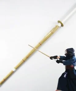 A bamboo Shinai sword with a Kendo martial artist demonstating sword use.