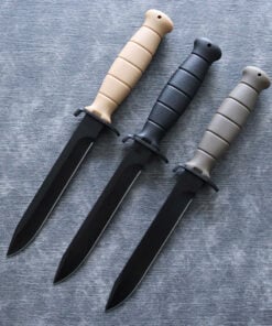 Three combat army daggers with different color handles and black blades lying on the floor.