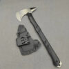 A tactical tomahawk displayed next to its scabbard.