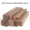 Multiple blocks of North American black Walnut wood stacked.