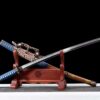 A Japanese Tachi Katana sword and its scabbard leaning against a wooden stand.