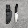 Fixed blade camping survival knife with a black handle and a silver blade next to its sheath, lying on a grey concrete floor.