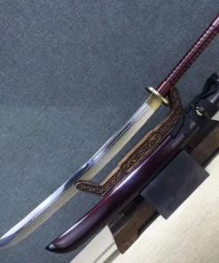 A two handed Chinese broadsword for sale, displayed next to its scabbard, on a small wooden stand.