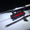 A single-edged Chinese sword displayed next to its scabbard, on a small wooden stand.