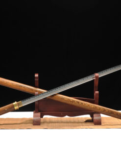 A Japanese Chokuto Katana sword, displayed crossed against its wooden scabbard, leaning against a small sword-stand.