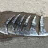 Six combat axe heads displayed on the ground.