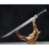 A straight, single edged combat sword balanced on a wood log branch.