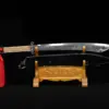 A Chinese Dadao sword displayed next to its scabbard, on asmall wooden stand.