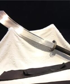 A Chinese Dadao sword displayed against a white sheet, with its scabbard below.