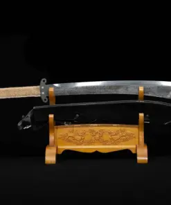 A Chinese Dadao sword displayed next to its scabbard, on asmall wooden stand.