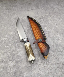 A hunting deer antler knife, displayed next to its leather sheath.