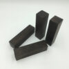 Four dark Ebony wood blocks.