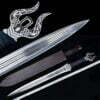 A fantacy short sword next to its scabbard and measurement tape, with product close-ups of the handle rear and blade tip.
