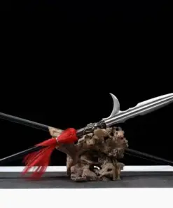 A Chinese hook spear weapon and its pole-handle extension leaning against a small wood log.