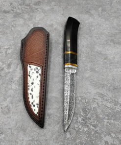 A fixed blade hunting knife, displayed next to its leather sheath.