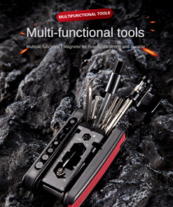 Knifeless multi tool with tools opened, resting on rocky ground.