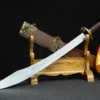 A Kung Fu sword with a yellow & red tassel, displayed with its scabbard leaning against a wooden stand.