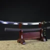 A little Chisa Katana sword and its scabbard displayed on a wooden stand.