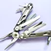 A folding survival multifunction tool with its pliers and other tools opened.