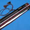 A one handed sword Jian, displayed next to its scabbard on a red colored sword-bag.