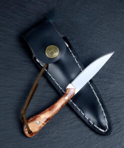 A small rabbit knife, displayed lying against its sheath.