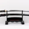A sharp Samurai sword displayed next to its black scabbard, on a small wooden stand.