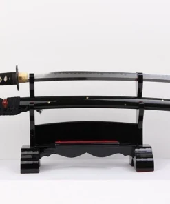 A sharp Samurai sword displayed next to its black scabbard, on a small wooden stand.