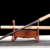 A Shikomizue sword displayed next to its wooden scabbard, on a small sword-stand.