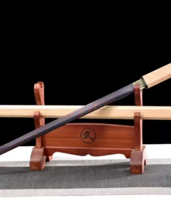 A Shikomizue sword displayed next to its wooden scabbard, on a small sword-stand.