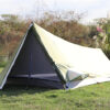 An erected tnnuel style, single man tent, displayed pitched in a field.