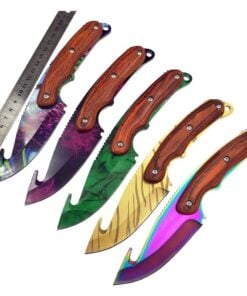 Five different color skinning knives next to a steel ruler.