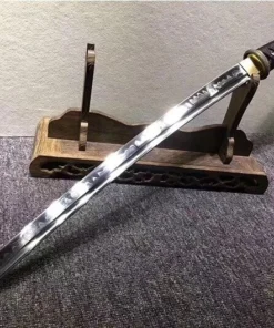 A Wakizashi small sword, displayed leaning against a small, wooden sword-stand.