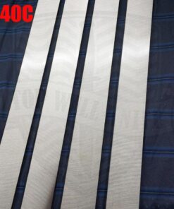 Four pieces of long stainless steel material lying on blie material, with red colored 440C written in the top left hand corner.