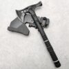 A tactical hammer war axe weapon lying against its abs tomahawk sheath.
