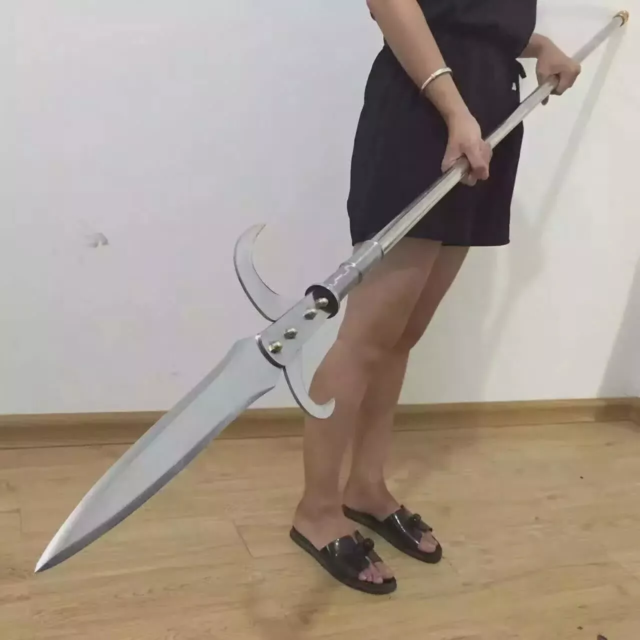 Warrior Spear A man holding a hooked warrior spear weapon.