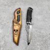A skeleton themed stabbing knife with knife sheath.
