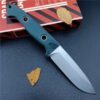 Fixed blade camping knife resting on a book.