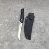 A game field dressing knife, displayed next to its Kydex sheath.