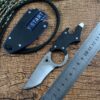 Best neck knife lying next to sheath and measurement ruler.