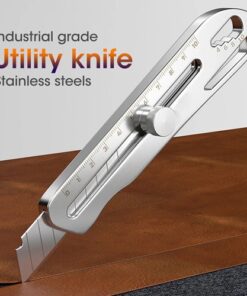A retractable utility carpenter knife cutting into a timber board.