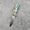Rainbow color pocket knife with blade opened.