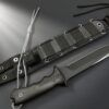 A black tactical combat knife displayed next to its sheath.