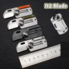 Four dog tag knife models displayed next to a steel ruler.