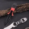 Two boat knife models of differing colors displayed against a small log.