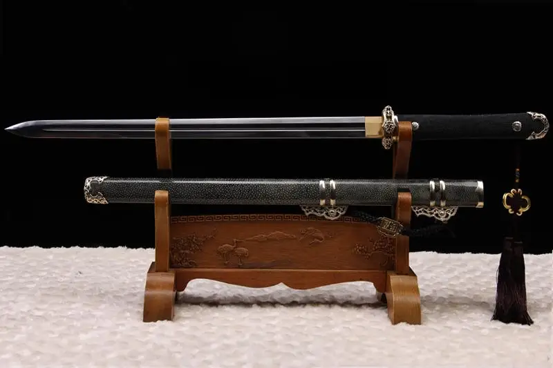 Chinese Straight Sword Jian A Chinese straight sword Jian, displayed next to its decorative scabbard, on a small wooden stand.