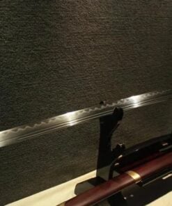 A Miao Dao, Chinese two handed sword, displayed on a wooden stand, with its scabbard below.